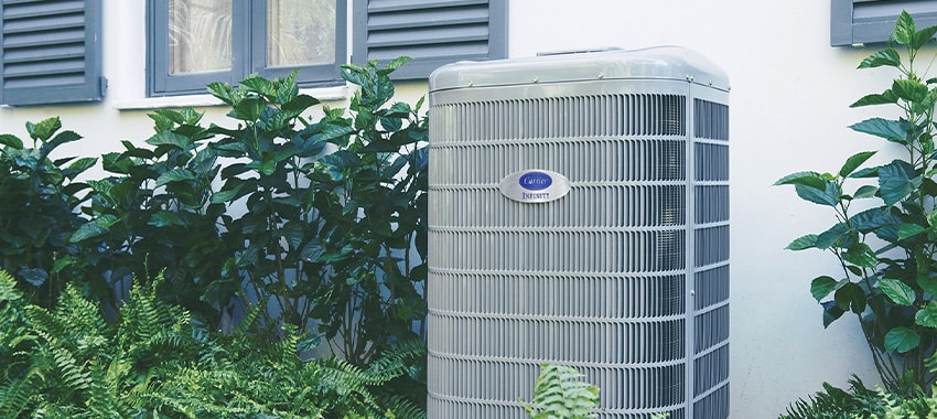 Carrier air conditioner behind homeowners house.